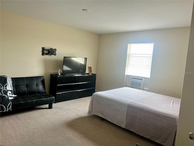 bedroom featuring cooling unit, carpet, and a textured ceiling