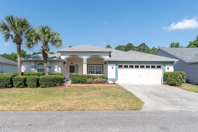 view of front facade with a front yard and a garage