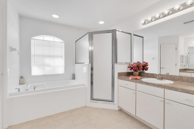 bathroom with tile patterned flooring, vanity, and plus walk in shower