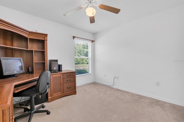 carpeted office featuring ceiling fan