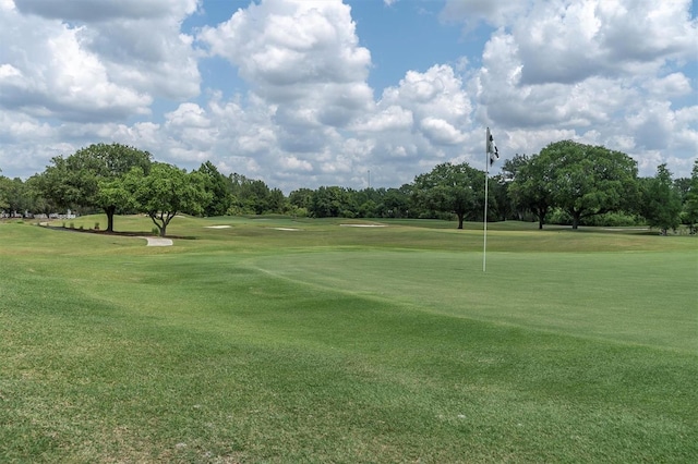 view of property's community with a lawn