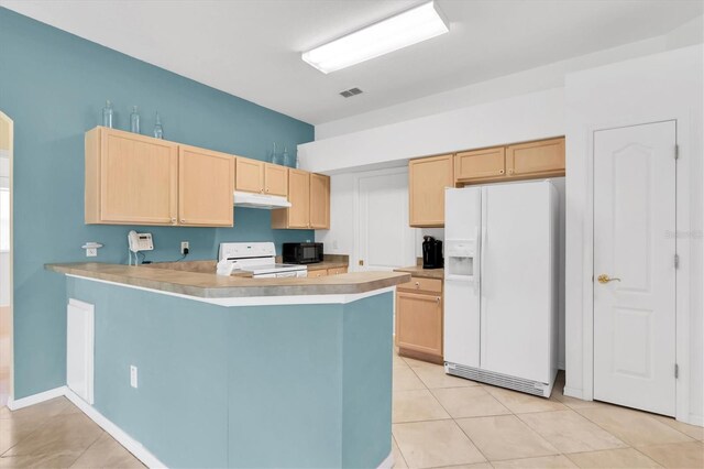 kitchen featuring light tile patterned floors, white appliances, kitchen peninsula, and light brown cabinetry