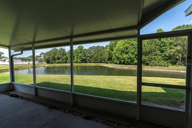 unfurnished sunroom featuring a water view