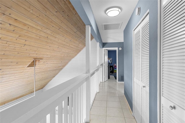 hall with visible vents and light tile patterned floors