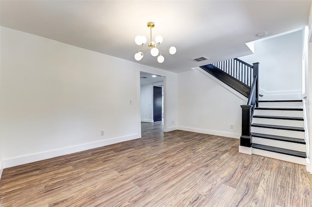 interior space featuring a notable chandelier and hardwood / wood-style flooring