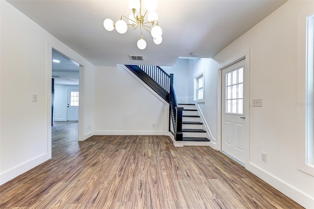 interior space with an inviting chandelier and wood-type flooring