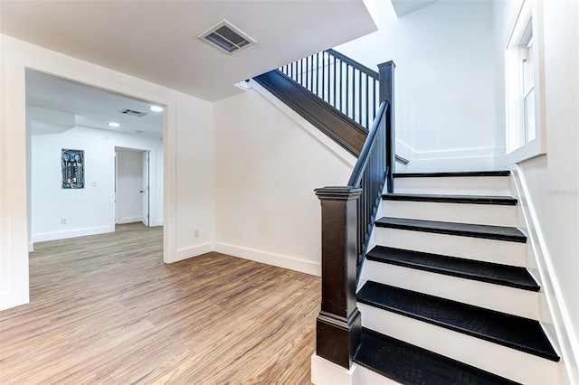 stairs with hardwood / wood-style flooring