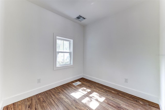 empty room with hardwood / wood-style floors