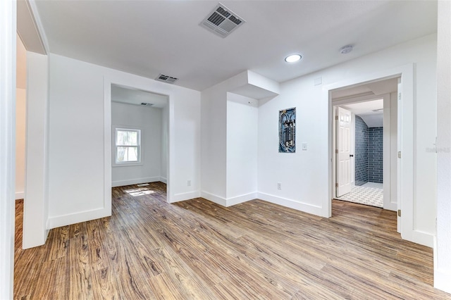 unfurnished room with hardwood / wood-style floors