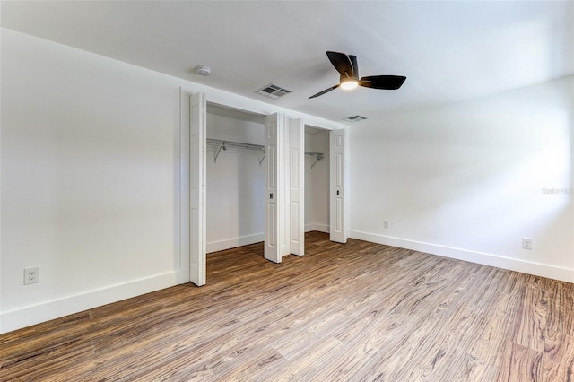 unfurnished bedroom featuring ceiling fan and hardwood / wood-style flooring