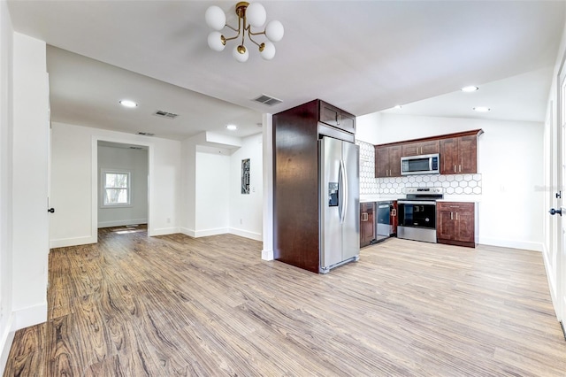 kitchen featuring light hardwood / wood-style floors, dark brown cabinetry, backsplash, lofted ceiling, and appliances with stainless steel finishes