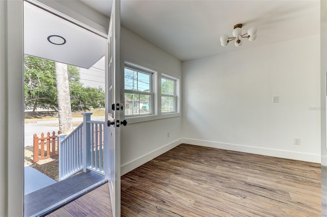 spare room featuring french doors and hardwood / wood-style flooring