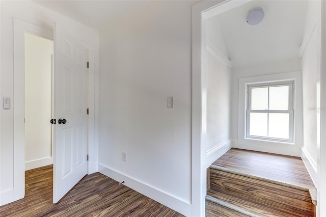 stairs with dark hardwood / wood-style floors and lofted ceiling