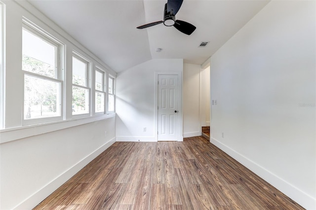 unfurnished room featuring ceiling fan, dark hardwood / wood-style floors, and lofted ceiling