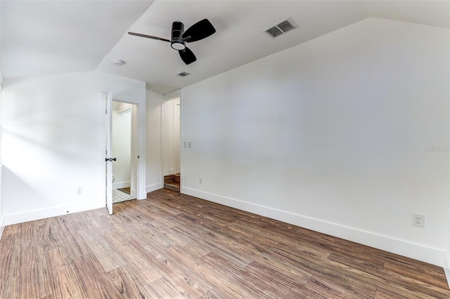 spare room featuring ceiling fan, vaulted ceiling, and hardwood / wood-style flooring