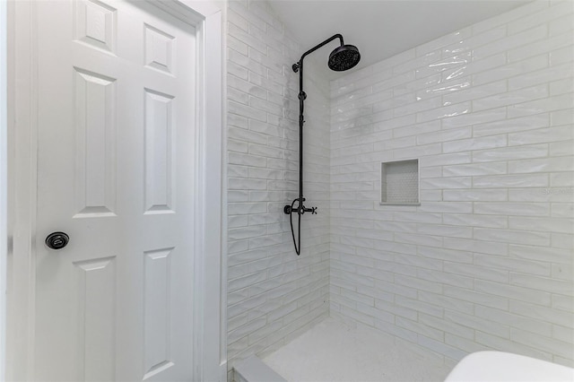 bathroom with tiled shower