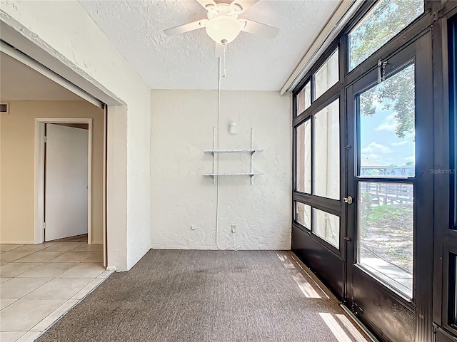 unfurnished sunroom with a healthy amount of sunlight and ceiling fan