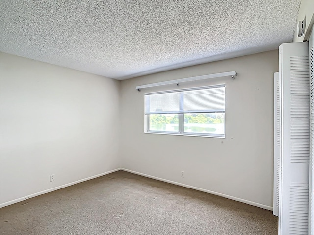 unfurnished bedroom with a textured ceiling, a closet, and carpet floors