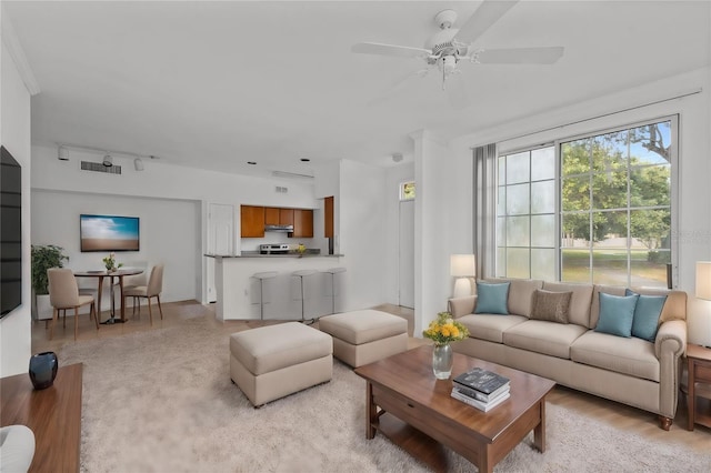 living room featuring light wood-type flooring and ceiling fan