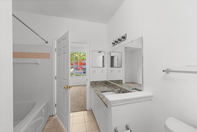 full bathroom featuring tile floors, tiled shower / bath, toilet, and vanity