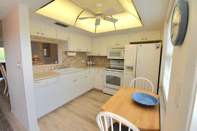 kitchen featuring ceiling fan, light hardwood / wood-style floors, white appliances, sink, and white cabinetry