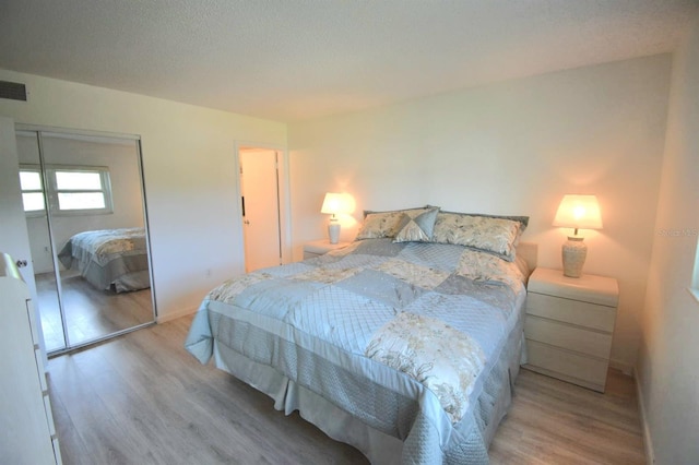 bedroom featuring hardwood / wood-style flooring and a closet