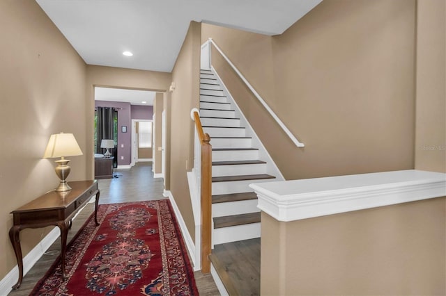 staircase with hardwood / wood-style flooring