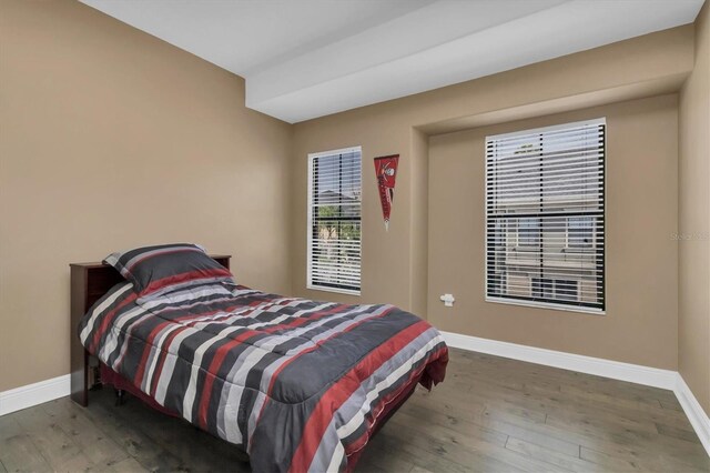 bedroom with dark wood-type flooring