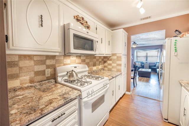 kitchen featuring ceiling fan, light hardwood / wood-style floors, white appliances, tasteful backsplash, and white cabinetry