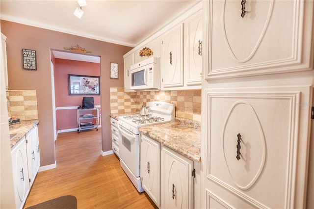 kitchen with light hardwood / wood-style flooring, white appliances, tasteful backsplash, light stone counters, and white cabinetry