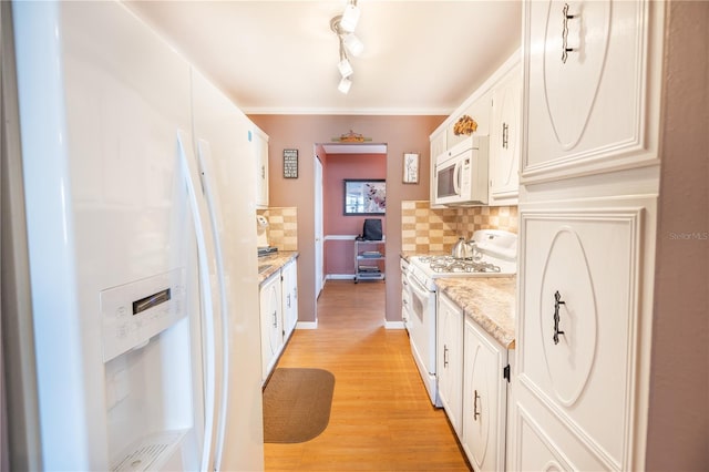 kitchen featuring light wood-type flooring, white appliances, white cabinets, track lighting, and tasteful backsplash