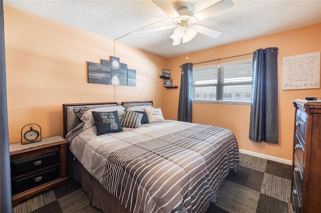 carpeted bedroom featuring ceiling fan and a textured ceiling