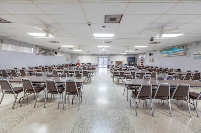 dining area with ceiling fan and a drop ceiling