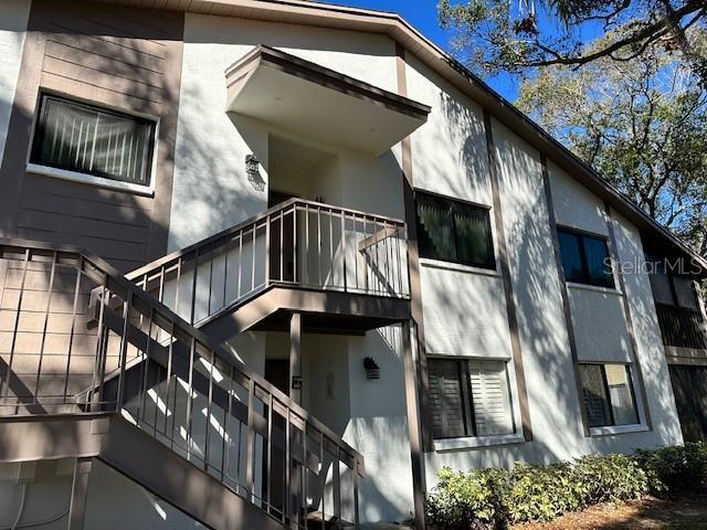 view of home's exterior with a balcony and stucco siding