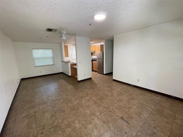 interior space featuring a textured ceiling and ceiling fan