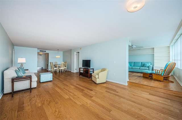 living room with ceiling fan and hardwood / wood-style flooring