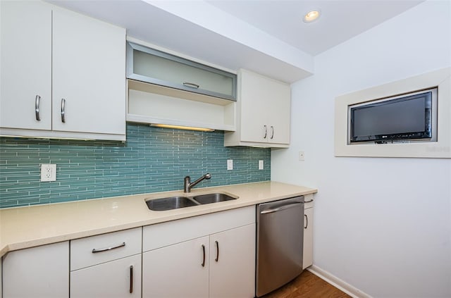 kitchen featuring dark hardwood / wood-style flooring, white cabinets, sink, tasteful backsplash, and dishwasher