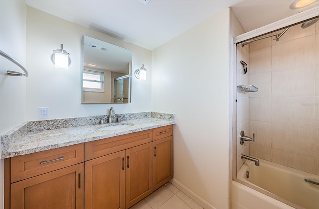 bathroom featuring oversized vanity, tiled shower / bath combo, and tile floors