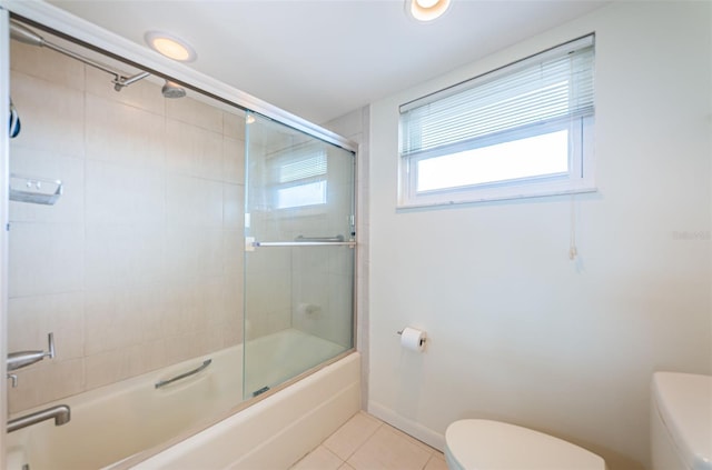 bathroom with shower / bath combination with glass door, toilet, and tile floors