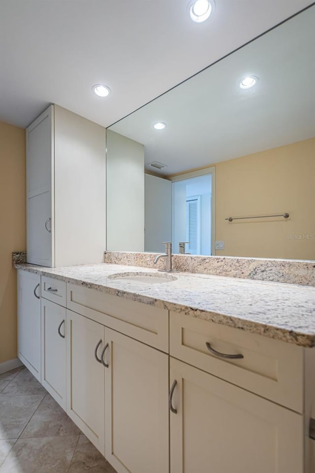 bathroom featuring tile flooring and vanity