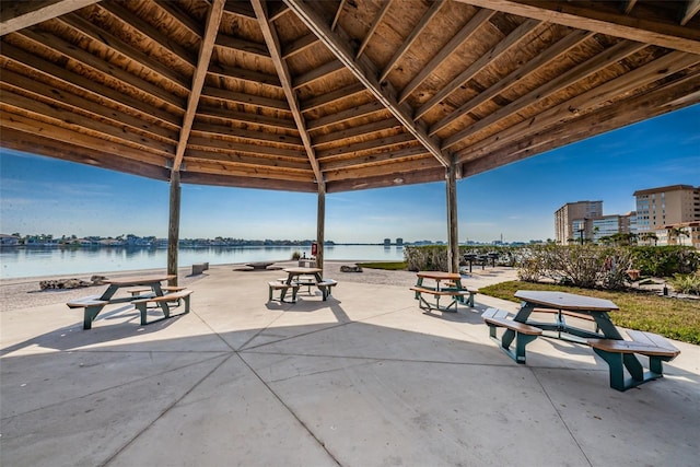 surrounding community featuring a patio area, a water view, and a gazebo