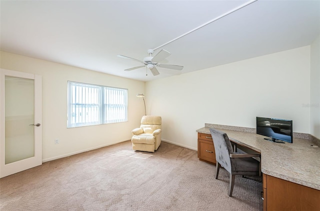 carpeted office with ceiling fan