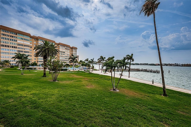 surrounding community featuring a water view and a lawn