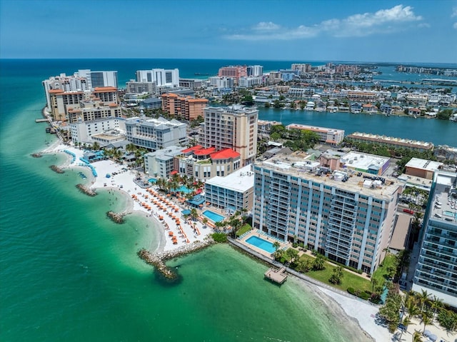 birds eye view of property featuring a beach view and a water view