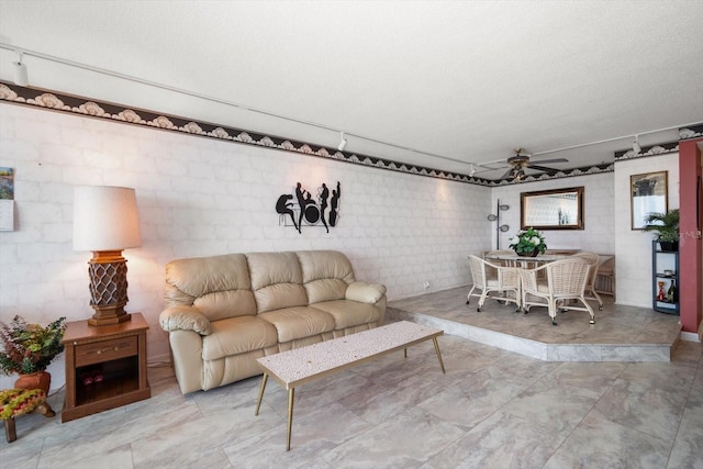 tiled living room featuring a textured ceiling and ceiling fan