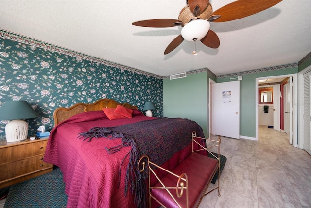 tiled bedroom featuring a textured ceiling and ceiling fan