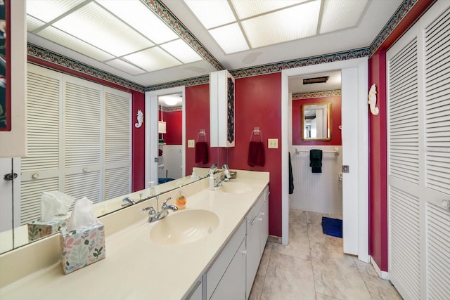 bathroom featuring dual vanity and tile floors