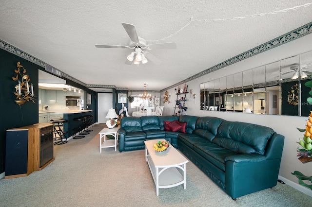 carpeted living room featuring ceiling fan with notable chandelier and a textured ceiling