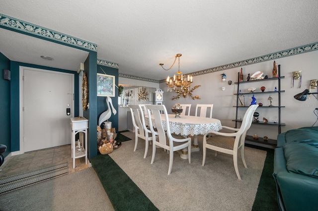 carpeted dining room with a notable chandelier and a textured ceiling