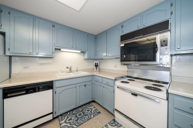 kitchen with blue cabinets, sink, white appliances, and backsplash